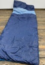 Old blue sleeping bag on the floor Royalty Free Stock Photo