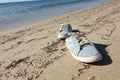 Old blue sneaker on beach.