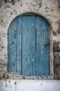 Old blue timber door in the scuffed wall