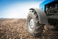 Old blue tractor close-up in a empty field. Agricultural machinery, field work. Royalty Free Stock Photo