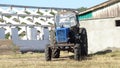 Old blue tractor in a field parking. Background picture.