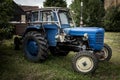 Old blue tractor standing in the garden