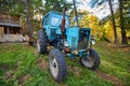 An old blue tractor stands in a farmyard Royalty Free Stock Photo