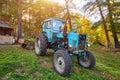 An old blue tractor stands in a farmyard Royalty Free Stock Photo