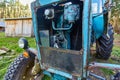 An old blue tractor stands in a farmyard Royalty Free Stock Photo