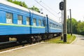 Old blue train is leaving the platfrom at the railway station Royalty Free Stock Photo