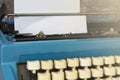 An old blue typewriter and trash paper on wooden desk. Copy space Royalty Free Stock Photo