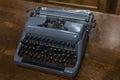 An old blue typewriter on a wooden table. Close-up. Top view Royalty Free Stock Photo