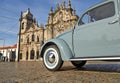 Old blue vintage car on old cobblestone road Royalty Free Stock Photo