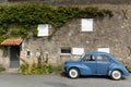 Blue vintage car outside house in Vouvant, France