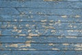 Old blue vintage wooden wall with cracked paint layer. Old painted wood planks