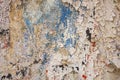 Old blue wall with damage, cracks and white peeling paint with red and black spots. rough surface texture Royalty Free Stock Photo