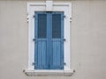 Old blue window and grey cement wall closed ancient facade shutter Royalty Free Stock Photo