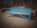 Old blue wooden bench in the sunny autumn park Royalty Free Stock Photo