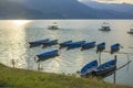 A Old blue wooden boats on the water against the backdrop of green mountains in the evening. solar track on the water. empty boat Royalty Free Stock Photo