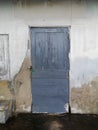 The old blue wooden door with dirty concrete Royalty Free Stock Photo