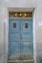 old blue wooden door with metallic knockers in town. Exterior design. Building facade. Royalty Free Stock Photo