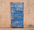 Old blue wooden door and orange wall in Roussillon in France Royalty Free Stock Photo