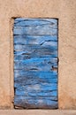 Old blue wooden door and orange wall in Roussillon in France Royalty Free Stock Photo