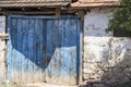 Old blue wooden door and stone wall, tile Royalty Free Stock Photo