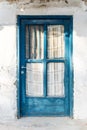 Old blue wooden door on a white wall Royalty Free Stock Photo