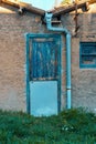 Old blue wooden door and window, cement wall in a country house Royalty Free Stock Photo