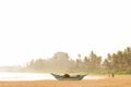 Old blue wooden fishing boat on a tropical sandy beach Royalty Free Stock Photo