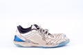 Old blue worn out futsal sports shoes on white background isolated