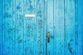 Old blue worn wooden door with letter box Royalty Free Stock Photo