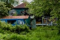 Old blue wrecked car in the courtyard of a village house Royalty Free Stock Photo