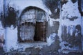 Old boarded-up prison window with iron bars, prison wall Royalty Free Stock Photo