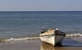 Old boat at the beach with the seagulls flying over the sea in the background Royalty Free Stock Photo