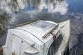 Old boat on the calm water with reflexion of blue sky Royalty Free Stock Photo