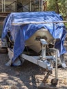 Old Boat Covered with Blue Tarp