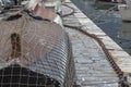 An old boat covered with a fishing net in a marina Royalty Free Stock Photo