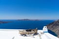 Old boat for decoration on a white roof. Santorini island, Greece