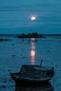 Old boat at low tide under a red moon Royalty Free Stock Photo