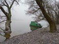 An old boat in the fog covered with frost in a willow grove. Royalty Free Stock Photo