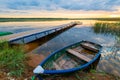 Old boat near the shore overlooking a wooden pier Royalty Free Stock Photo