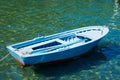 An old boat near a wooden bridge on a beautiful lake. Fishing boat on the pier. Royalty Free Stock Photo