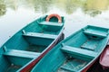 Old boat with oar near river or beautiful lake. Calm sunset on the nature. Fishing boat Royalty Free Stock Photo