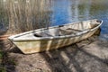 An old boat over a small lake. Accessories for anglers Royalty Free Stock Photo