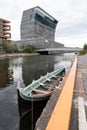 Old boat parked beside the canal in the front of Munch Museum in Oslo, Norway under the cloudy sky Royalty Free Stock Photo