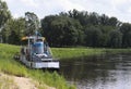 Old boat on the river bank on a sunny summer day Royalty Free Stock Photo