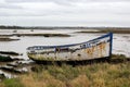 An old boat on the sand on the side of an estuary Royalty Free Stock Photo