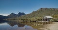 old boat shed at dove lake with cradle mt in the distance on a calm summer morning at cradle mountain Royalty Free Stock Photo