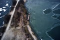 Old boat ship, trapped, frozen in winter ice lake, docked in pier, aerial top down view Royalty Free Stock Photo