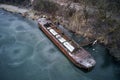 Old boat ship, trapped, frozen in winter ice lake, docked in pier, aerial top down view Royalty Free Stock Photo