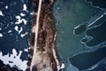 Old boat ship, trapped, frozen in winter ice lake, docked in pier, aerial top down view Royalty Free Stock Photo