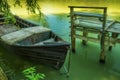 An old boat and a simple wooden pier from old boards Royalty Free Stock Photo